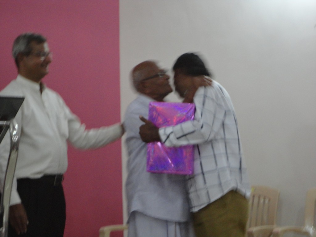 Father-of-Pr.-Thomas-George-hands-over-a-token-of-love-to-our-loving-contractor-Mr.-Saji-Thomas-Parel,-who-completed-the-building-without-waiting-for-the-balance-payment-of-Rs.-29-lacs